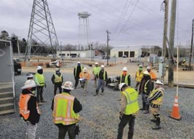 Langston Construction field crew in PPE during a substation toolbox meeting