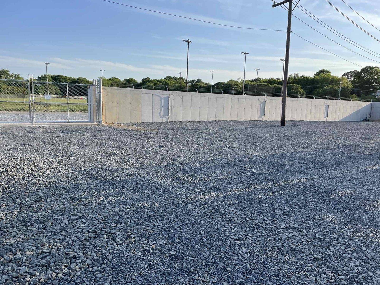 Completed precast ballistic perimeter wall and gate at a substation compound