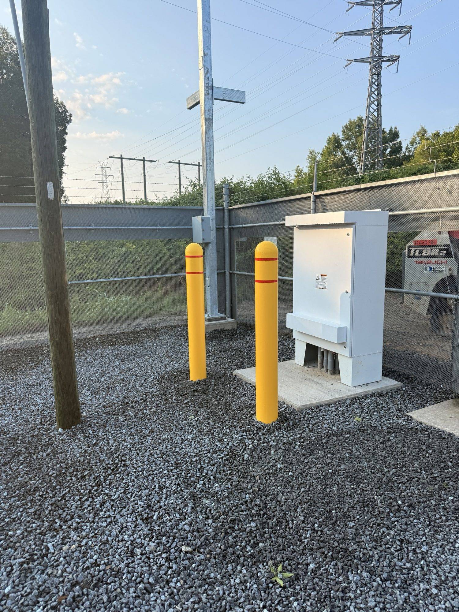 Concrete equipment pad, conduit stubs and protective bollards