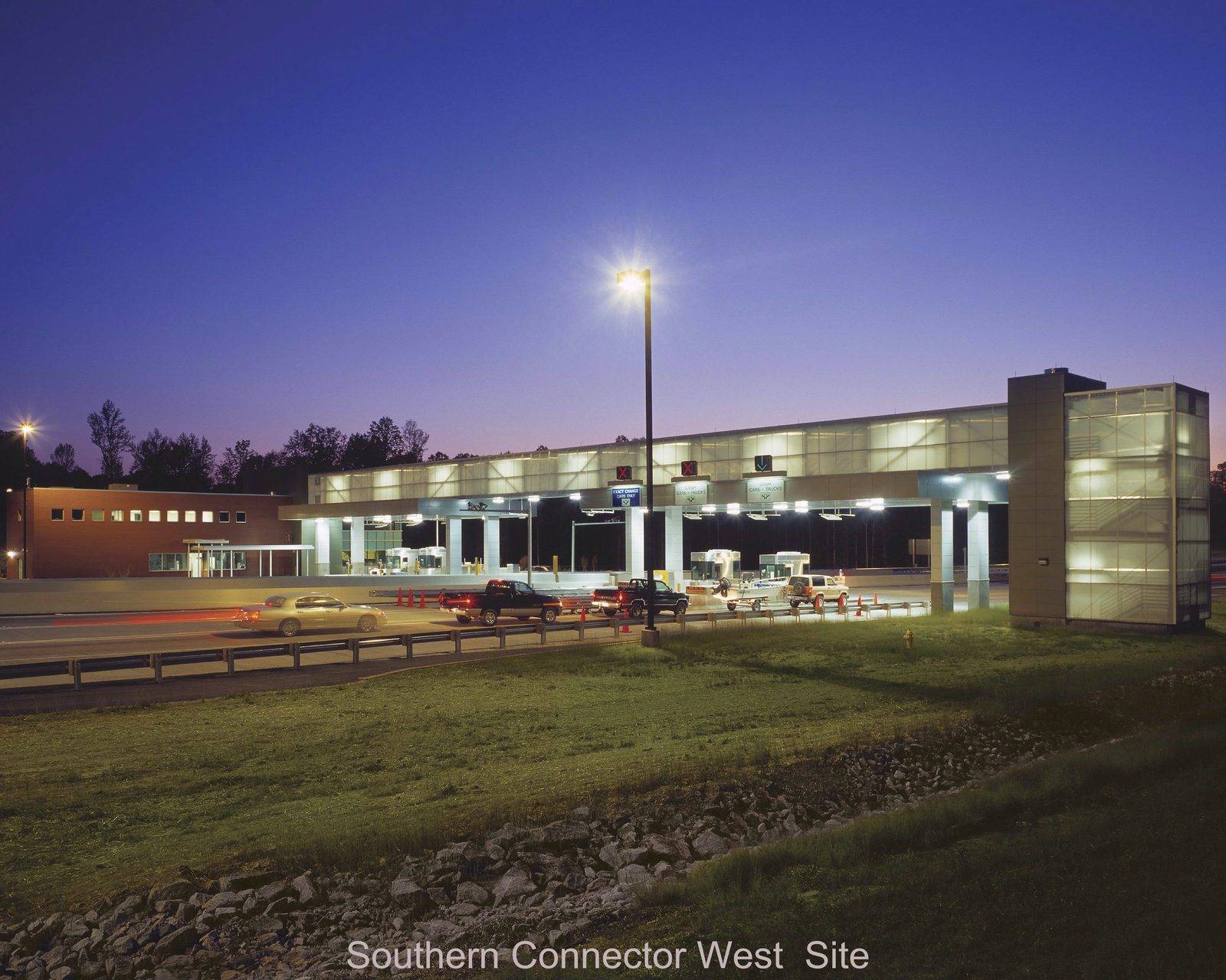 Southern Connector West toll plaza transportation infrastructure at dusk