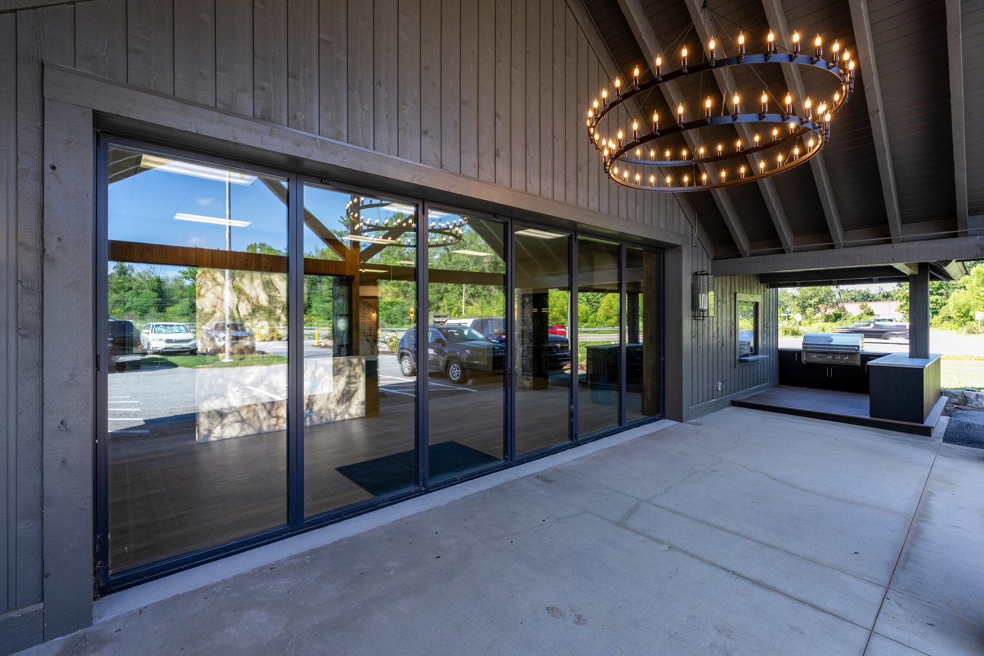 Covered outdoor gathering space and glass bi-parting door wall at the GBS Fletcher showroom