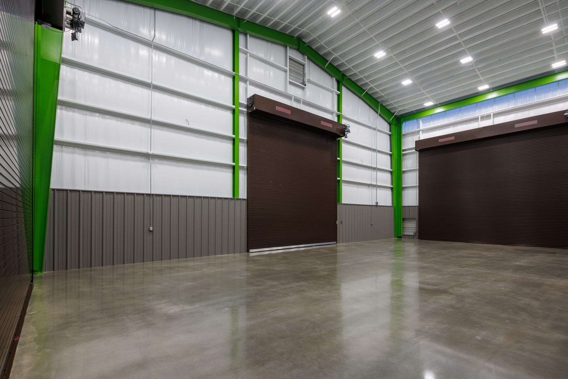 Shop bay with polished concrete floor and roll-up doors in the Luck Stone operations facility