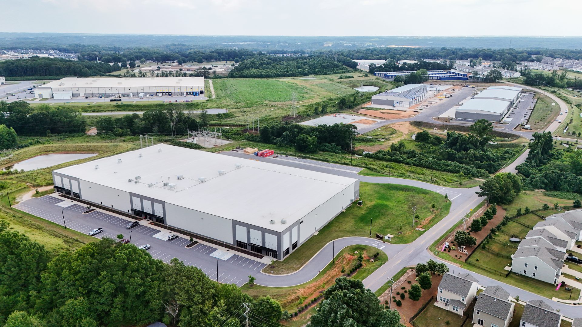 Wide aerial view of the MECART facility building, parking and site in Greenville, SC