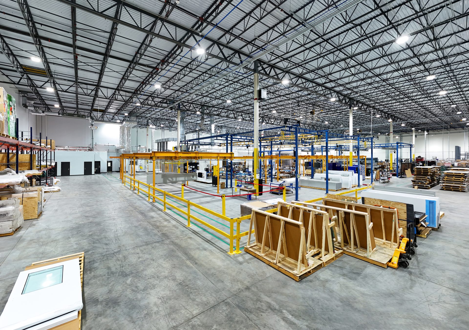 MECART production floor with assembly areas, overhead rails and LED high-bay lighting