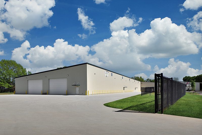 Exterior of the SMF expansion in Anderson, SC with concrete paving and perimeter fencing